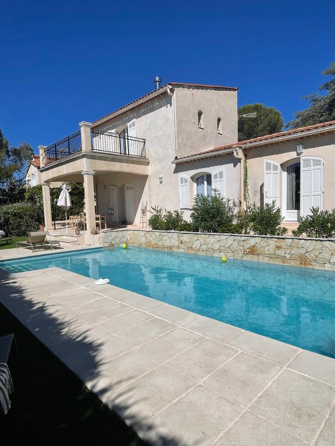 Villa-Fassade mit Balkon und Pool